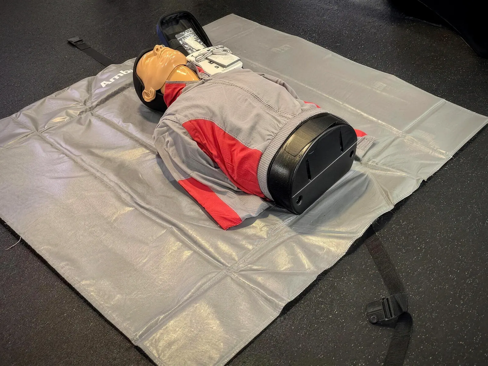 Adult CPR training manikin and AED trainer set up on a mat, ready for a hands-on Pulse CPR class