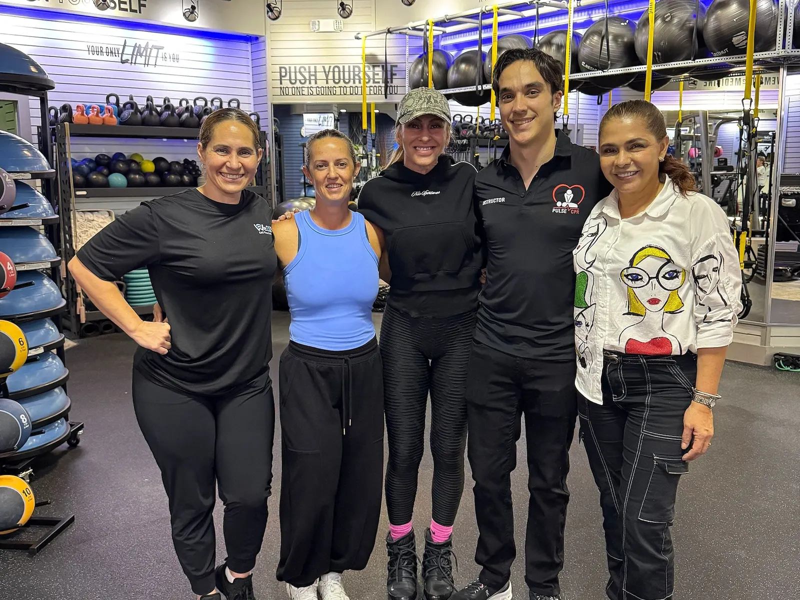Pulse CPR instructor Peter Asencio with a group of students after a CPR class